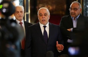 Iraqi Prime Minister Haider al-Abadi, center, holds a press conference before leaving to United States at Baghdad airport, Iraq, Monday, April 13, 2015. (AP Photo/Khalid Mohammed)