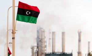 The new Libyan flag flutters outside an oil refinery in Zawiya on September 23, 2011. Total SA's Libyan joint-venture is set to restart oil production at its 40,000 barrels-a-day in Al-Jurf offshore field. Most of Libya's output of 1.7 million barrels a day was shut down after the revolution erupted in February. AFP PHOTO/Leon Neal (Photo credit should read LEON NEAL/AFP/Getty Images)