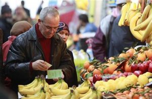 An Algerian man buys fruit at the Bab El Oued market in Algiers